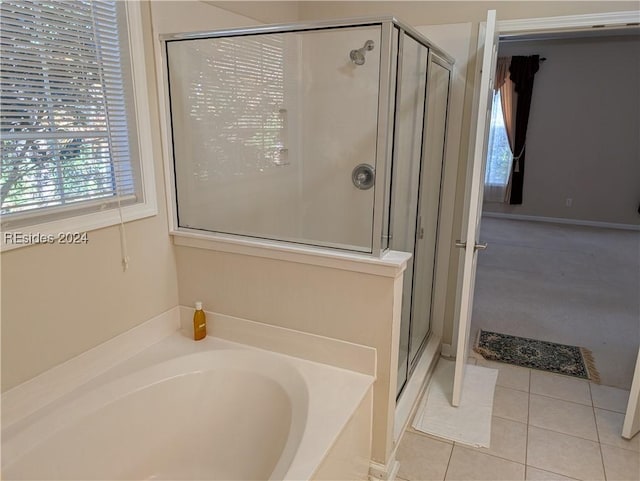 bathroom featuring tile patterned flooring and independent shower and bath