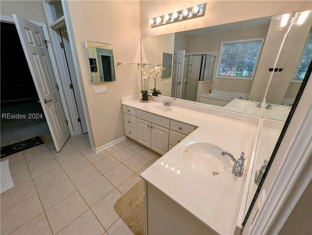 bathroom with tile patterned floors, independent shower and bath, and vanity