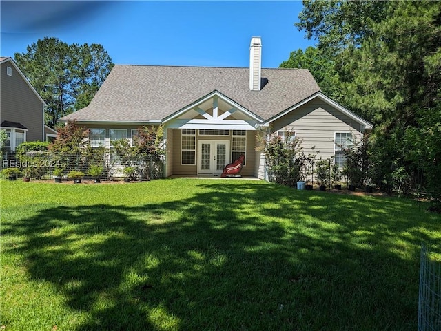 back of house with a yard and french doors