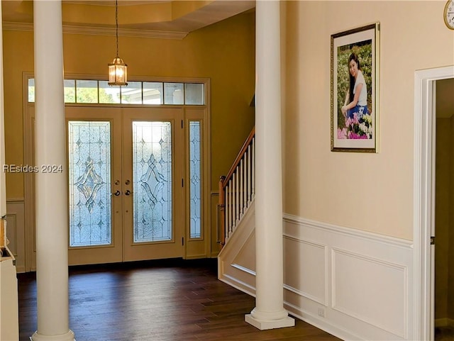 foyer with ornate columns, ornamental molding, dark wood-type flooring, and french doors