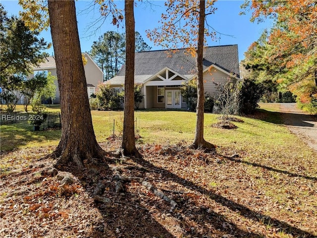 view of front facade featuring french doors and a front lawn