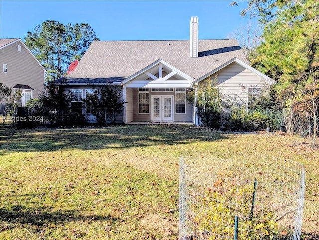 back of house with a lawn and french doors