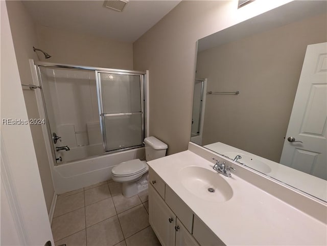 full bathroom featuring enclosed tub / shower combo, tile patterned floors, toilet, and vanity