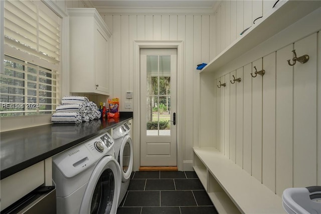 clothes washing area with cabinets, separate washer and dryer, a healthy amount of sunlight, and dark tile patterned flooring