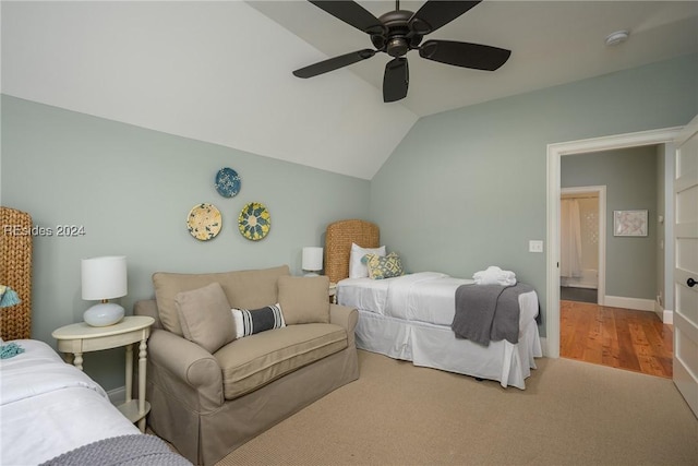 carpeted bedroom with vaulted ceiling and ceiling fan