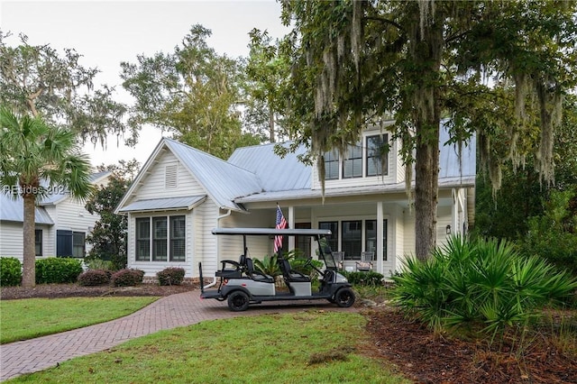 view of front of house with a porch and a front yard