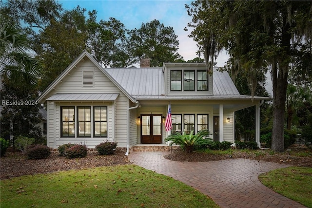 view of front of property featuring a front yard and french doors