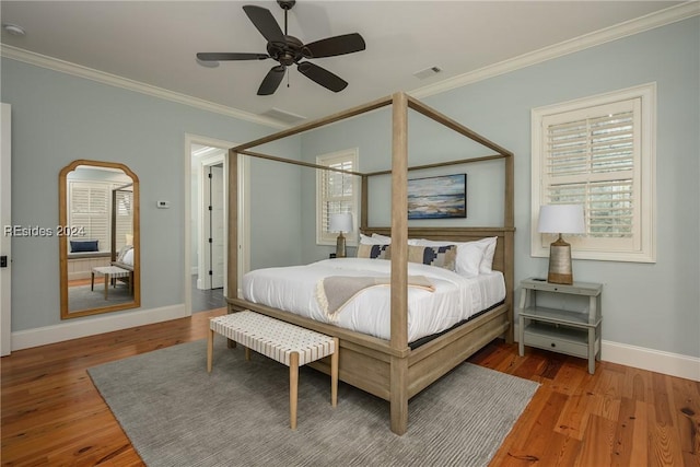 bedroom with wood-type flooring, ornamental molding, and ceiling fan