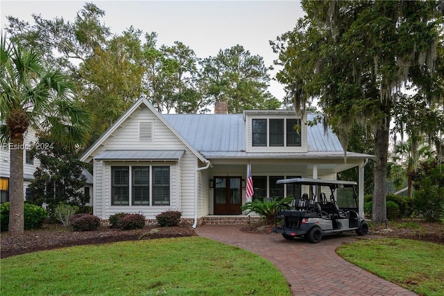 view of front of property with a porch and a front lawn