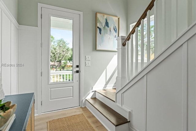 doorway featuring plenty of natural light and light hardwood / wood-style floors