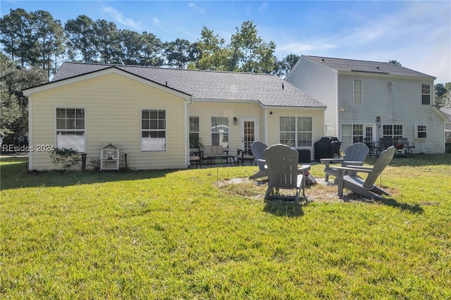 back of property featuring a lawn