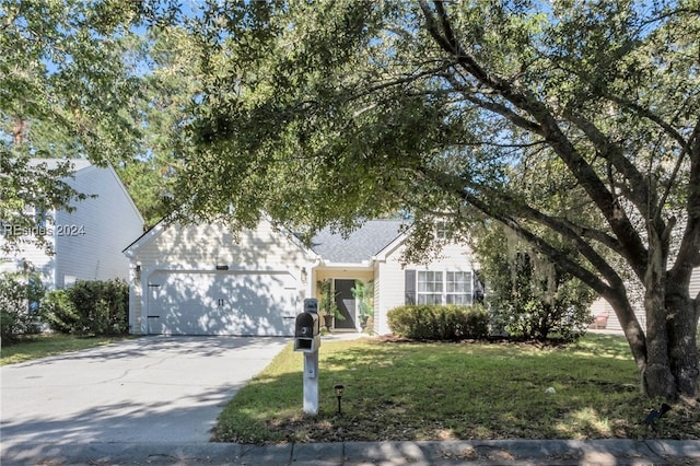 view of front of home featuring a garage and a front lawn