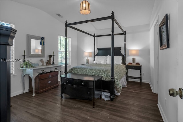 bedroom featuring dark wood-type flooring and vaulted ceiling