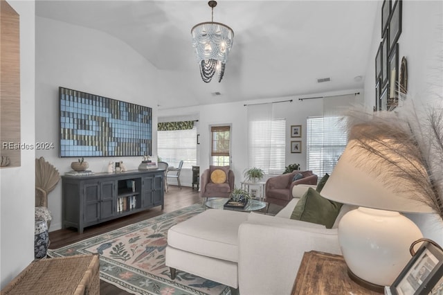 living room featuring lofted ceiling, a notable chandelier, and dark hardwood / wood-style flooring