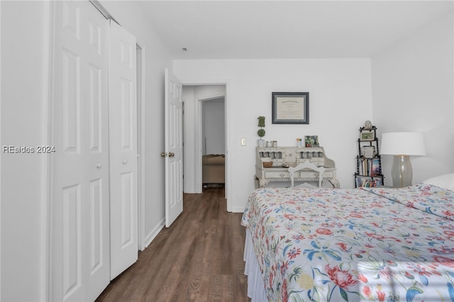 bedroom with dark wood-type flooring and a closet