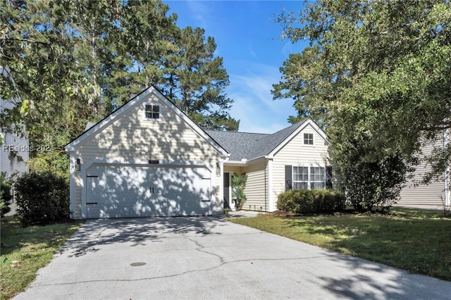 view of front of property with a garage and a front lawn