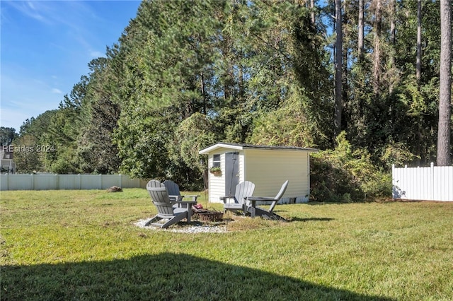 view of yard featuring a storage unit and a fire pit