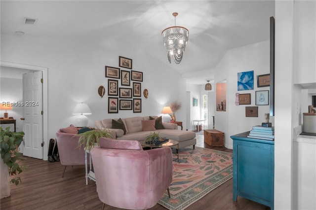 living room featuring dark wood-type flooring, vaulted ceiling, and a notable chandelier