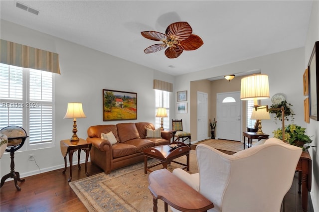 living room with ceiling fan, plenty of natural light, and dark hardwood / wood-style flooring