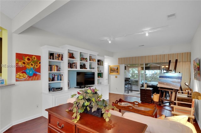 living room with hardwood / wood-style floors, track lighting, and a textured ceiling