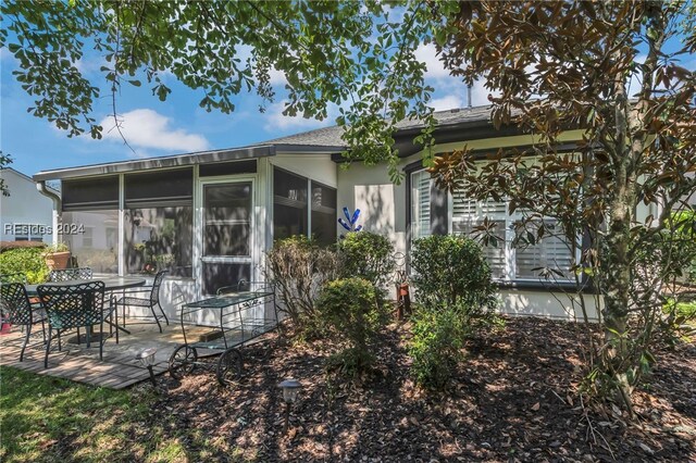 back of house with a sunroom