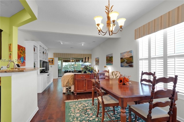 dining space featuring dark hardwood / wood-style flooring, a notable chandelier, and sink