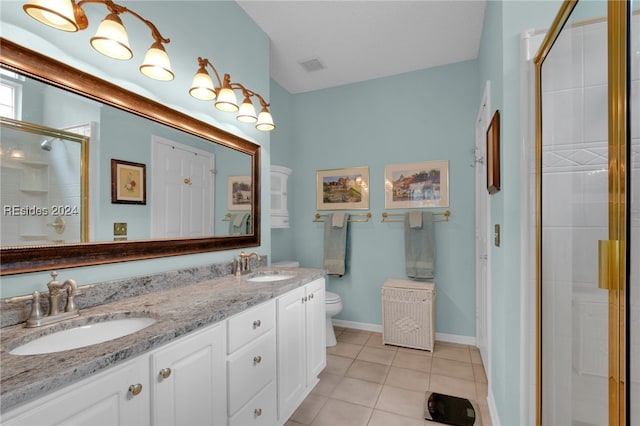 bathroom featuring walk in shower, vanity, toilet, and tile patterned flooring