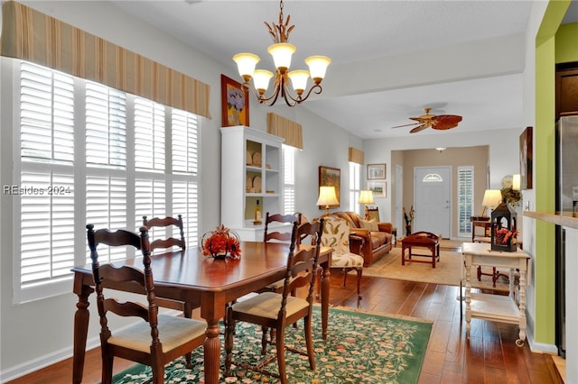 dining area with hardwood / wood-style flooring, plenty of natural light, and ceiling fan with notable chandelier