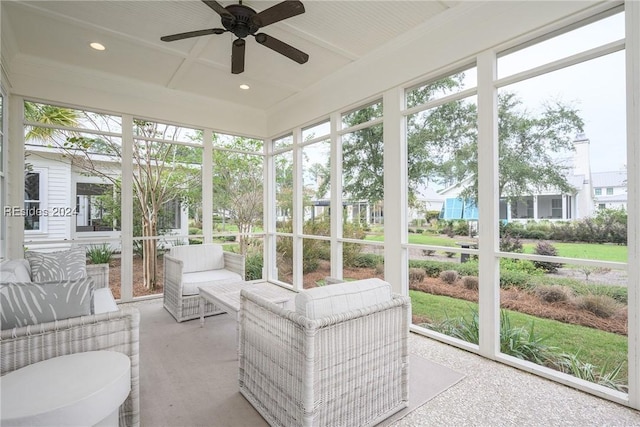 sunroom with ceiling fan and coffered ceiling