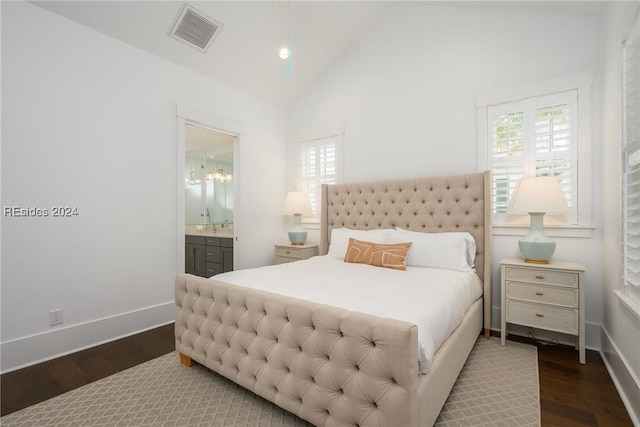 bedroom with ensuite bathroom, lofted ceiling, and dark hardwood / wood-style floors