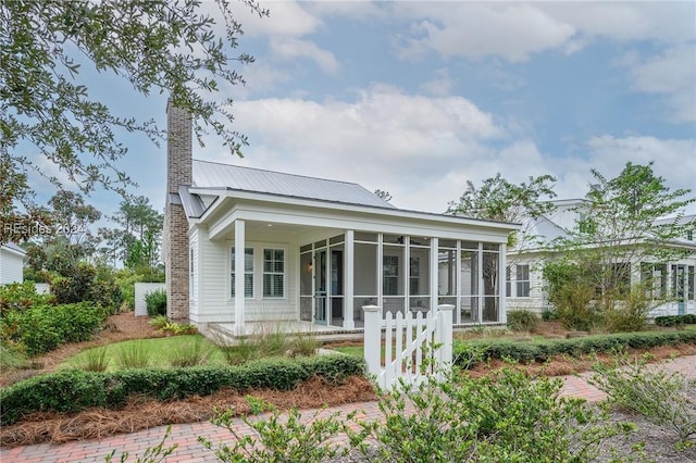 back of house featuring a sunroom