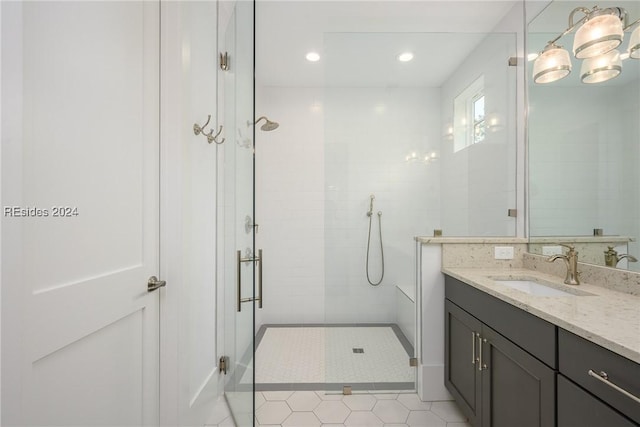 bathroom featuring vanity, tile patterned floors, and walk in shower