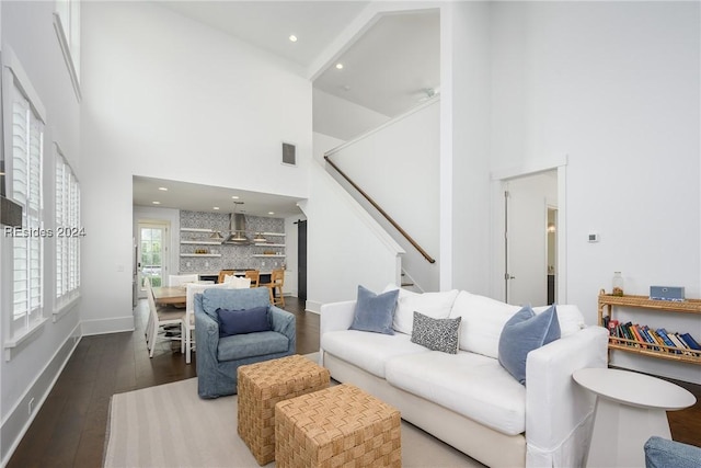 living room with hardwood / wood-style flooring and a high ceiling