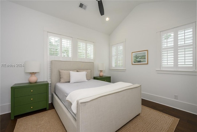 bedroom with ceiling fan, lofted ceiling, and dark hardwood / wood-style floors