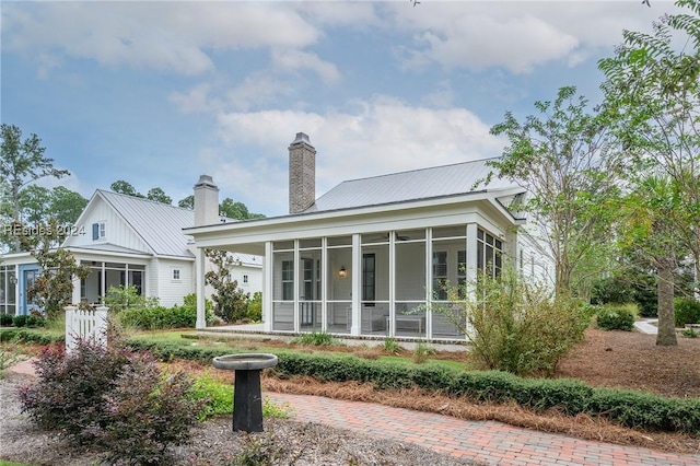 rear view of house with a sunroom