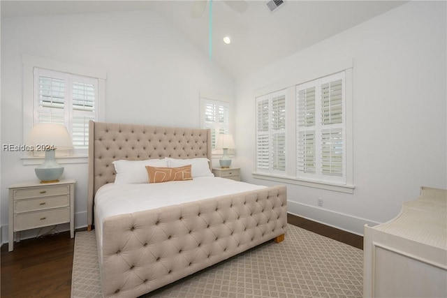 bedroom with ceiling fan, dark hardwood / wood-style flooring, and vaulted ceiling