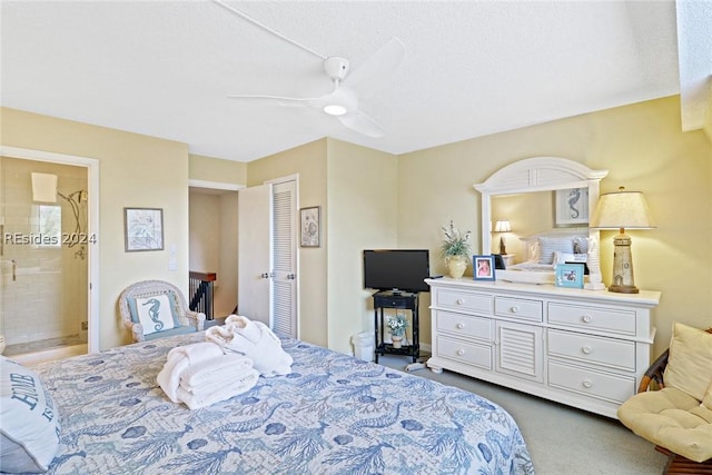 carpeted bedroom with ceiling fan, a closet, and ensuite bath