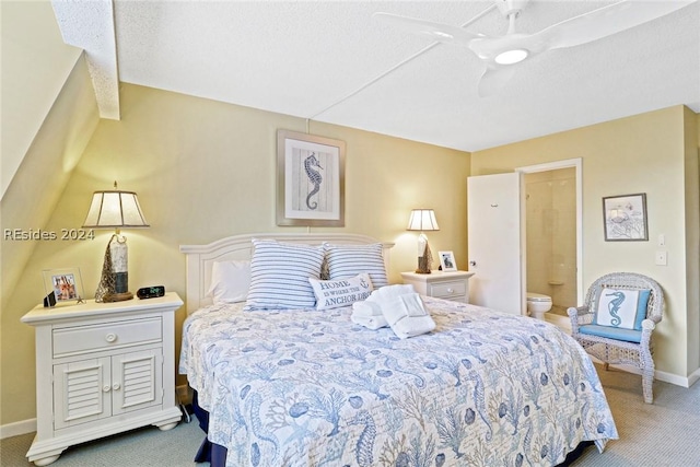 carpeted bedroom featuring a textured ceiling, ceiling fan, and ensuite bath