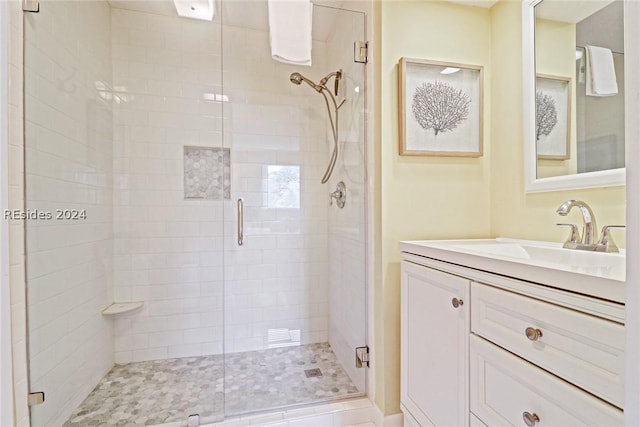 bathroom featuring vanity and a shower with shower door