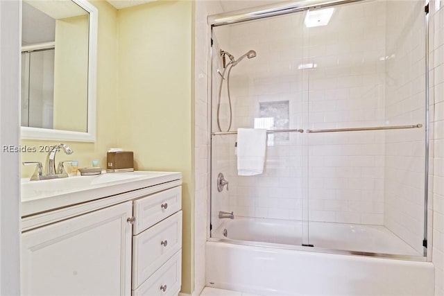 bathroom with vanity and enclosed tub / shower combo