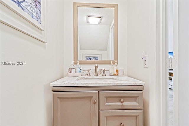 bathroom with vanity and a textured ceiling