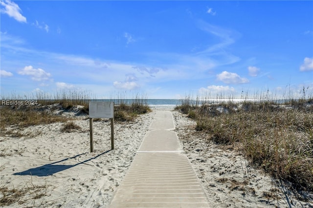 view of property's community with a beach view and a water view