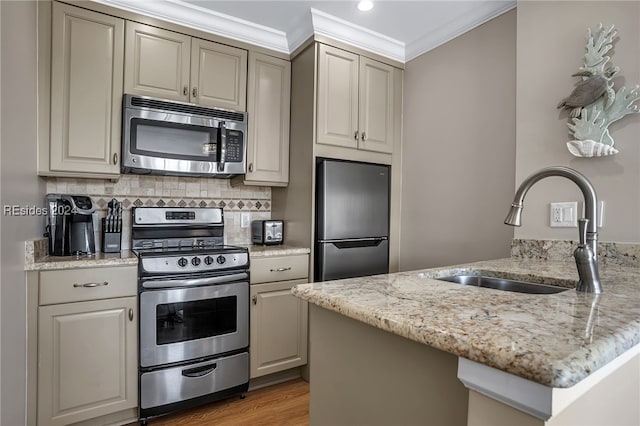 kitchen featuring appliances with stainless steel finishes, tasteful backsplash, sink, light stone counters, and crown molding