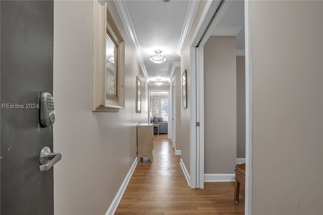 hall featuring crown molding and light wood-type flooring