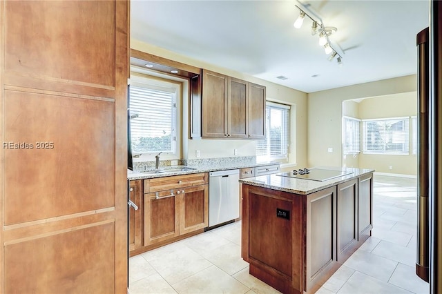 kitchen featuring sink, light tile patterned floors, dishwasher, a center island, and black electric cooktop