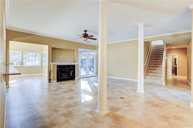 unfurnished living room featuring french doors, ceiling fan, ornamental molding, and decorative columns