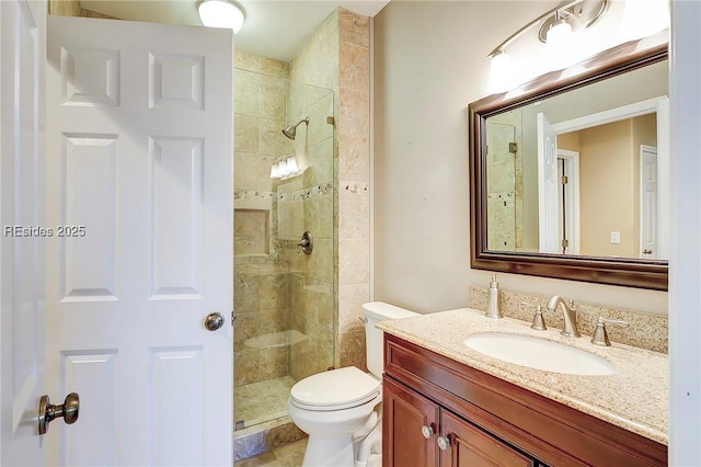 bathroom featuring vanity, toilet, and an enclosed shower