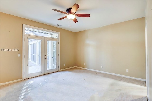 unfurnished room featuring french doors and ceiling fan