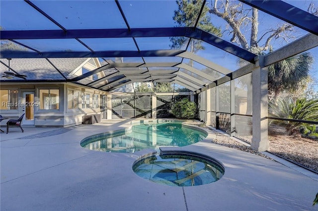 view of swimming pool featuring a lanai, a patio, and an in ground hot tub