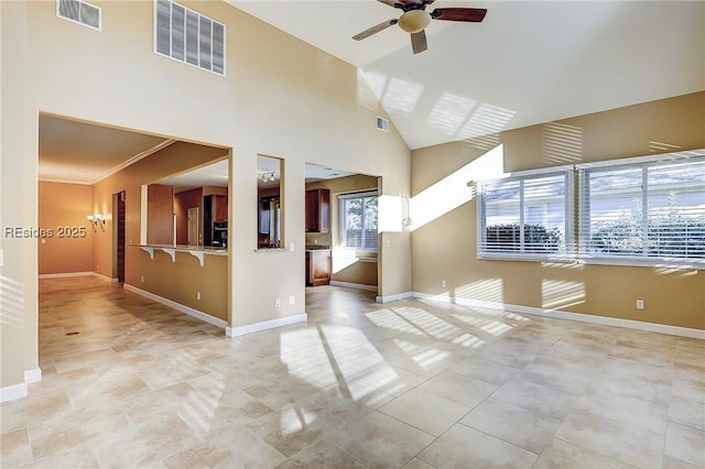 empty room with lofted ceiling, crown molding, and ceiling fan